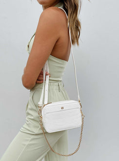 Crossbody bag 40% post-consumer recycled polyester 18% post-consumer recycled polyurethane 18% polyurethane 14% calcium carbonate 10% wood fiber Faux croc leather  Removable chain shoulder strap  Removable / adjustable crossbody strap  Zip fastening  Internal pockets  Flat base 