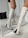 Knee high boots Princess Polly Exclusive Upper: 100% PU Lining: 100% Textile Outsole: 100% TPU Faux patent leather  Zip fastening at side  Pointed toe  Block heel 