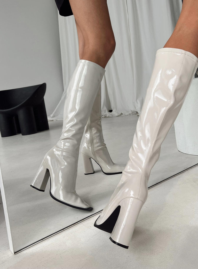 Knee high boots Princess Polly Exclusive Upper: 100% PU Lining: 100% Textile Outsole: 100% TPU Faux patent leather  Zip fastening at side  Pointed toe  Block heel 
