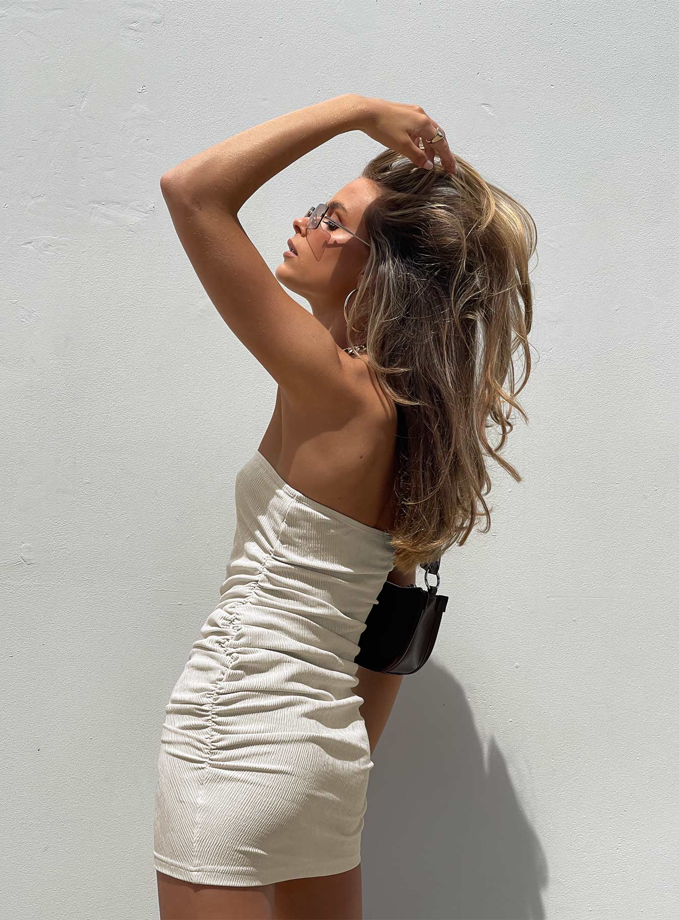 side view of model wearing Princess Polly Twiggy Mini Dress Beige 