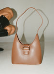 Shoulder bag Faux leather material Fixed shoulder strap Magnetic button fastening Gold-toned hardware Flat base