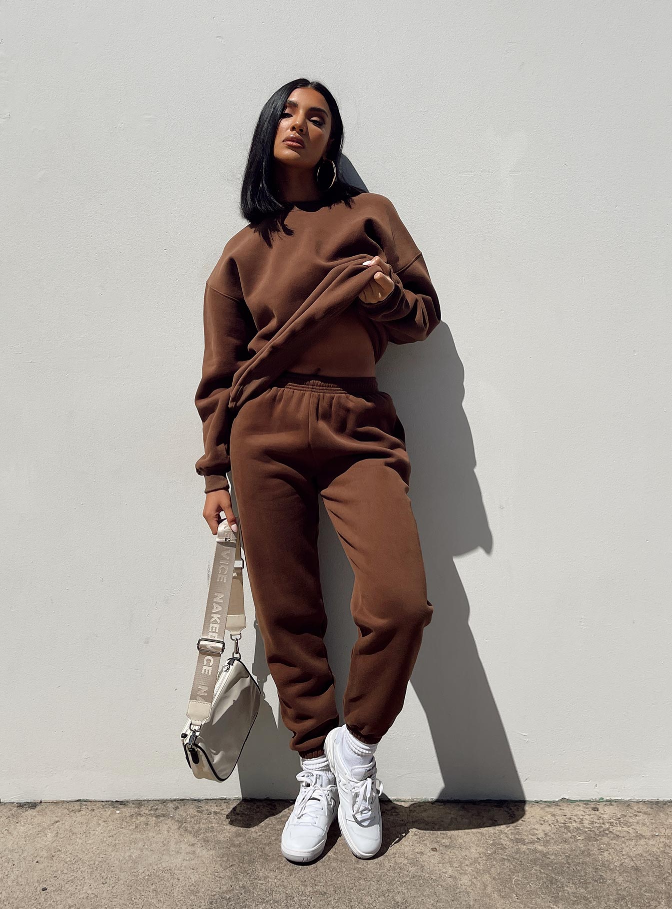 side view of model wearing Princess Polly Club Basic Trackpants Brown 