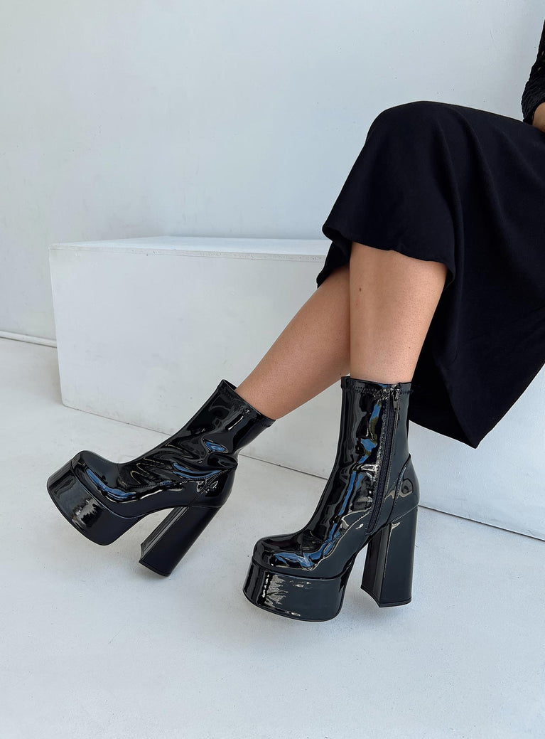 Platform boots Faux patent leather material Zip fastening at side Block heel Rounded toe Padded insole 