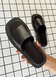 Slides Faux leather material  Single wide upper  Square toe  Padded footbed 