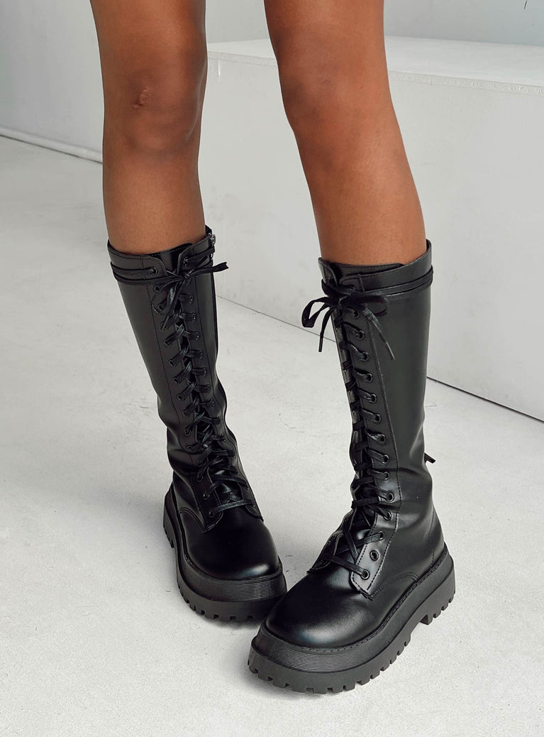 Combat boots Faux leather material  Lace up front  Zip fastening at side  Chunky base  Treaded sole  Mid-calf length 