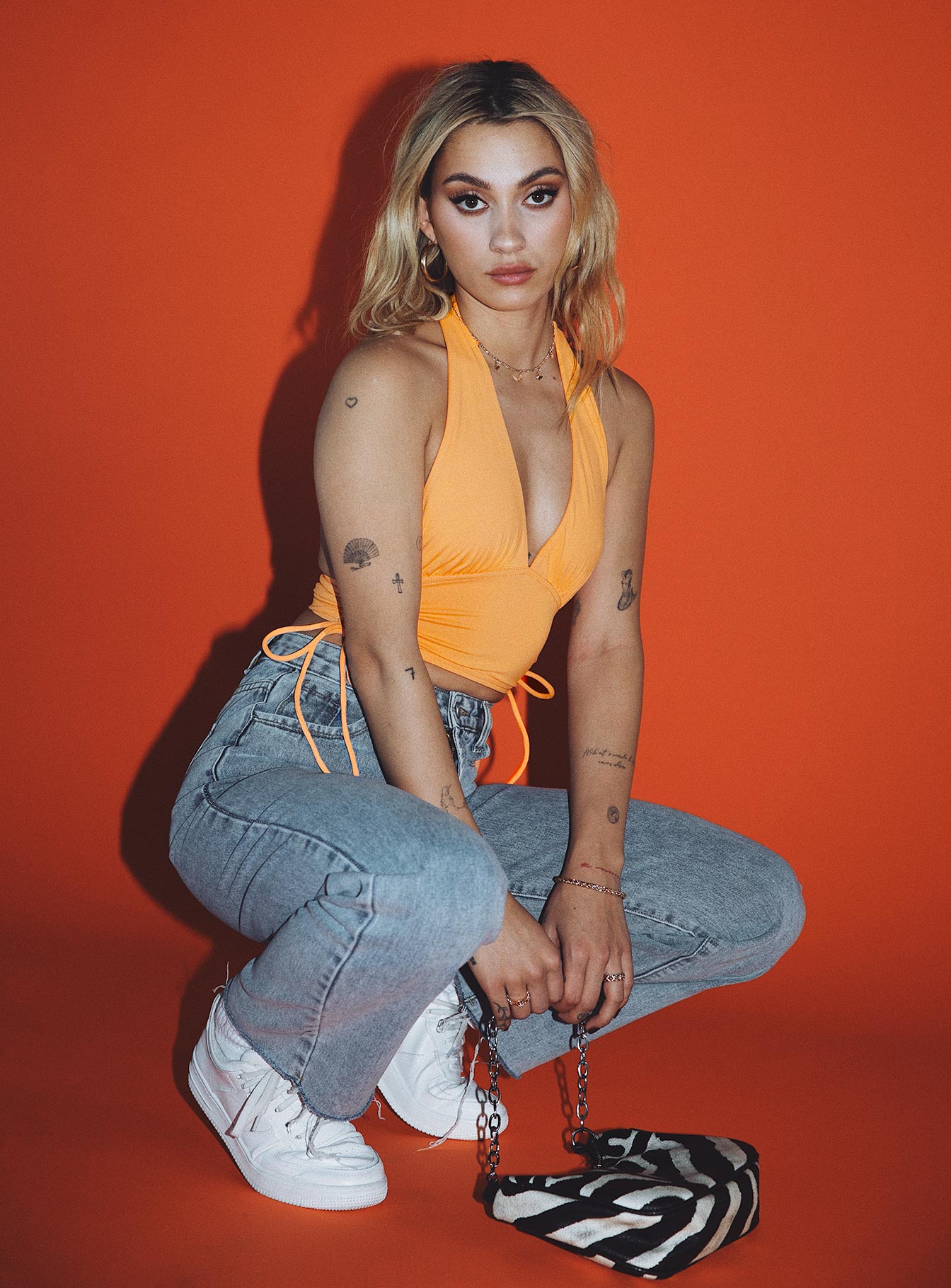 side view of model wearing Princess Polly Penelope Halter Top Orange 