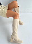 Knee high boot Faux leather material Zip fastening at side Block heel Square toe Padded footbed