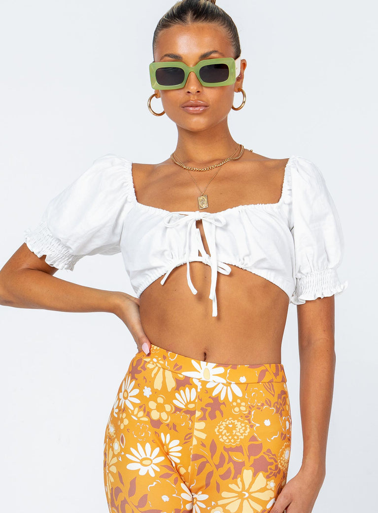Crop top  70% rayon 30% linen  Can be worn on or off the shoulder  Elasticised shoulders  Puff sleeves  Double tie front fastening  Shirred back panel  Slightly sheer