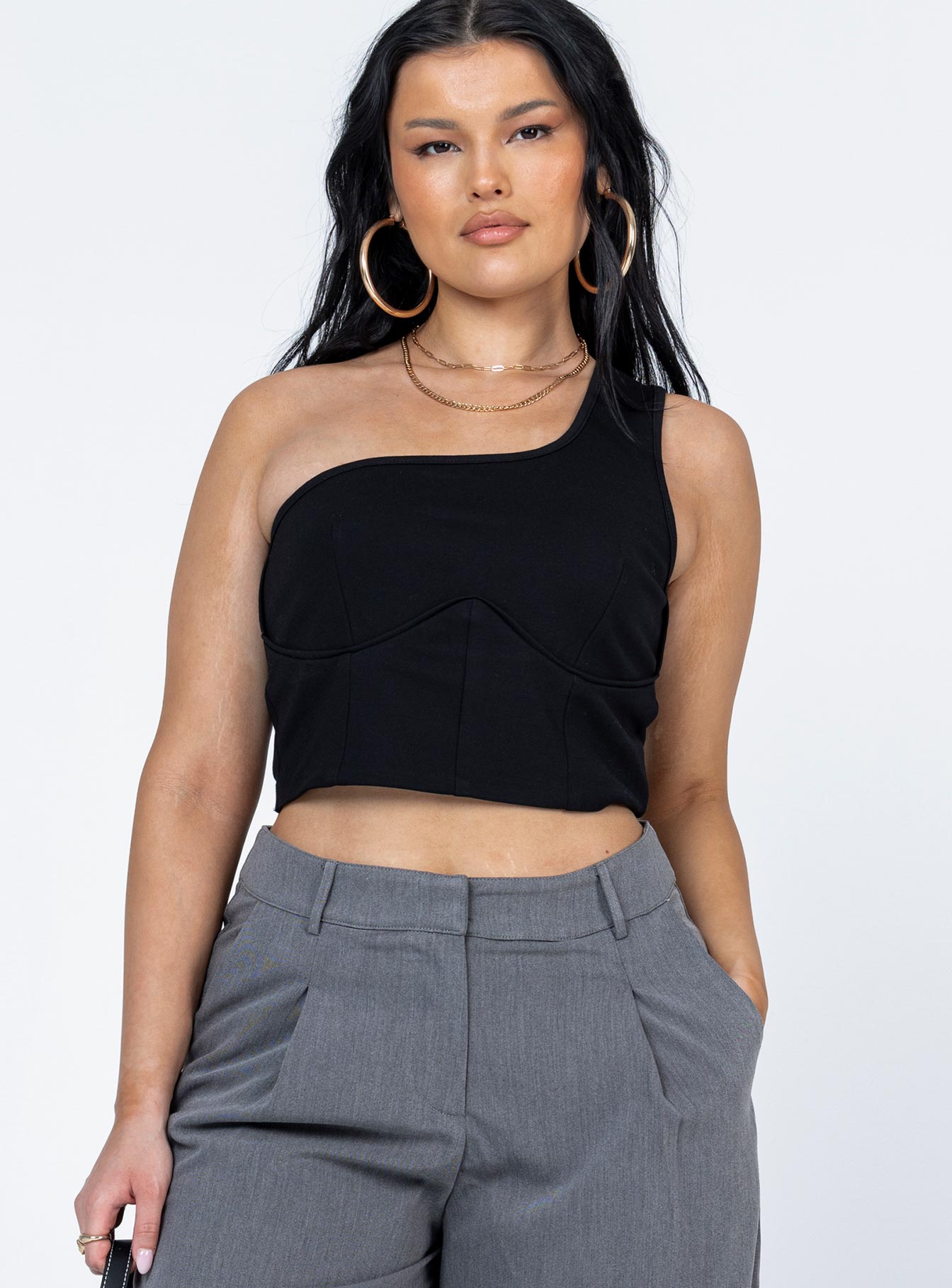 front view of model wearing Princess Polly Meranti Top Black Sleeveless Asymmetric Neckline 