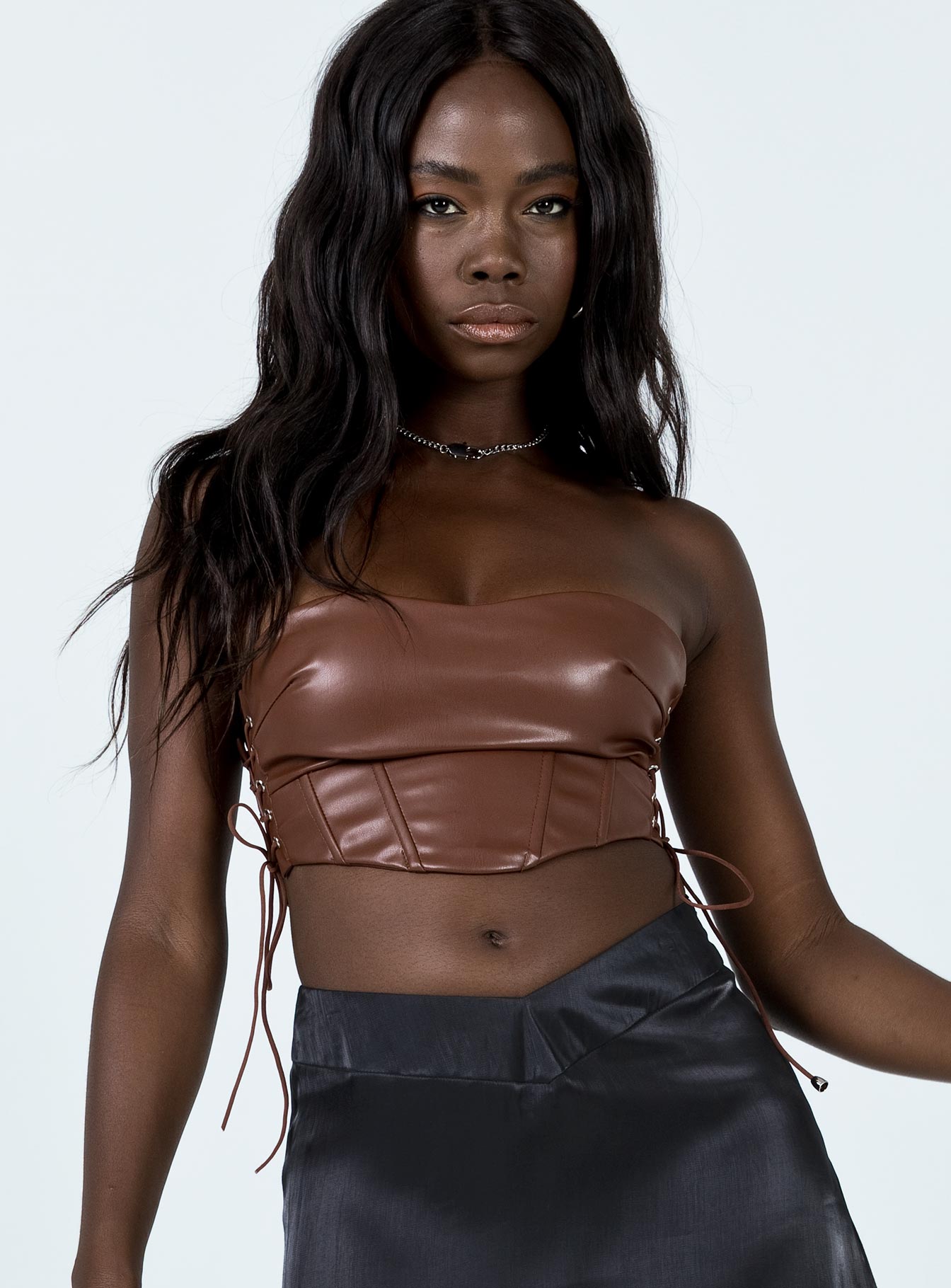 front view of model wearing Princess Polly Maddox PU Strapless Top Brown 