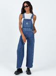 Overalls Mid wash denim  Embroidered graphic at chest  Adjustable shoulder straps Chest & leg pockets Four classic pockets  Button fastening at hips Wide leg 