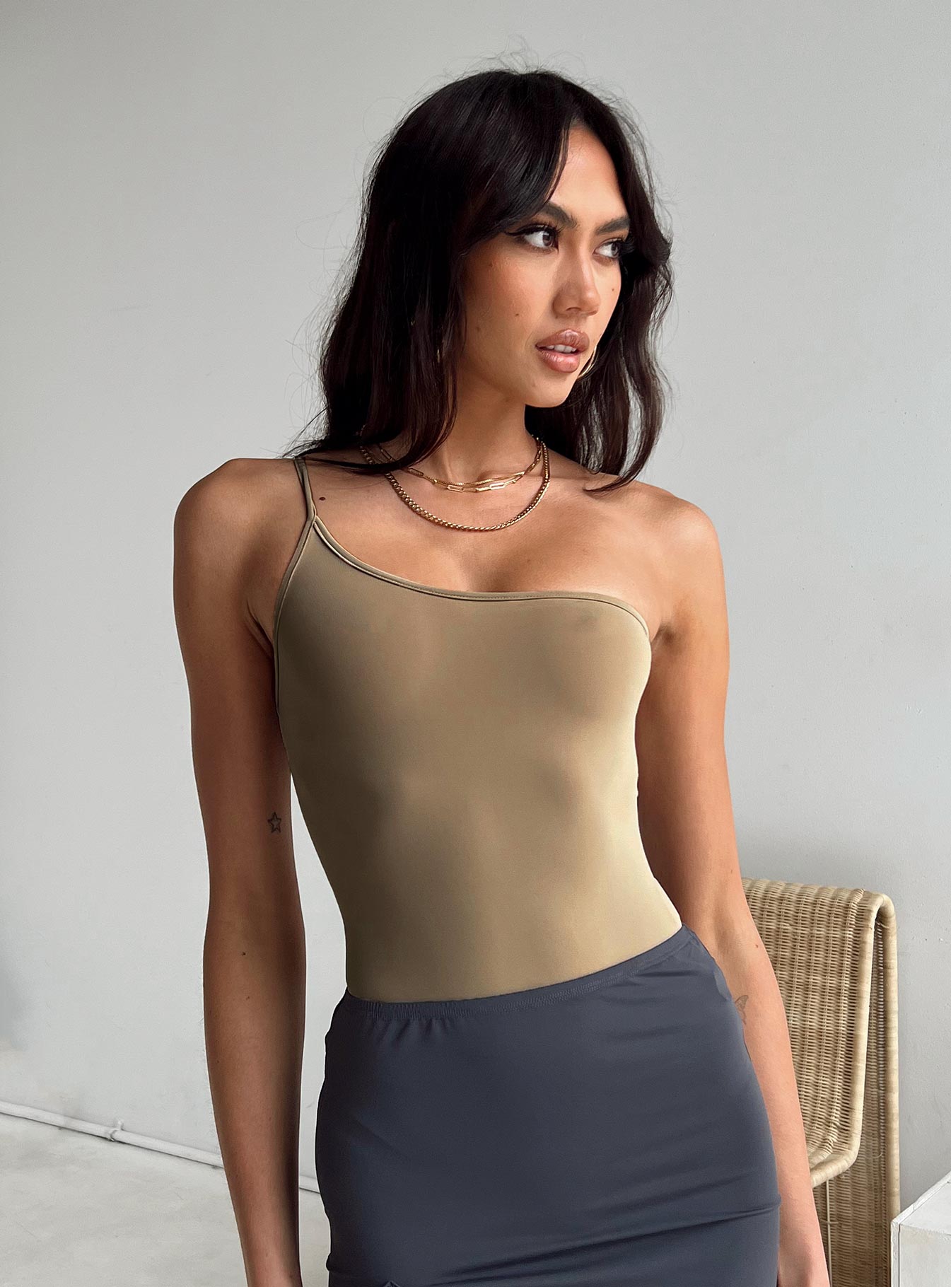 front view of model wearing Princess Polly Hutter Bodysuit Beige Sleeveless Asymmetric Neckline 