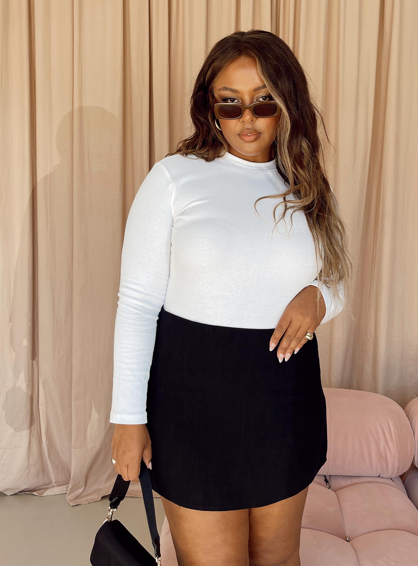 side view of model wearing Princess Polly Maleny Long Sleeve Bodysuit White Curve Full Sleeves Crew Neck 