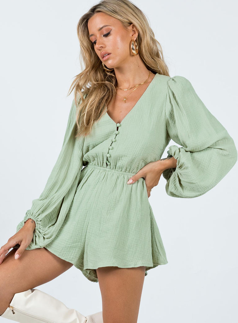 Long sleeve romper Muslin material Balloon style sleeves V-neckline Button fastening at front Elasticated band at waist Non-stretch