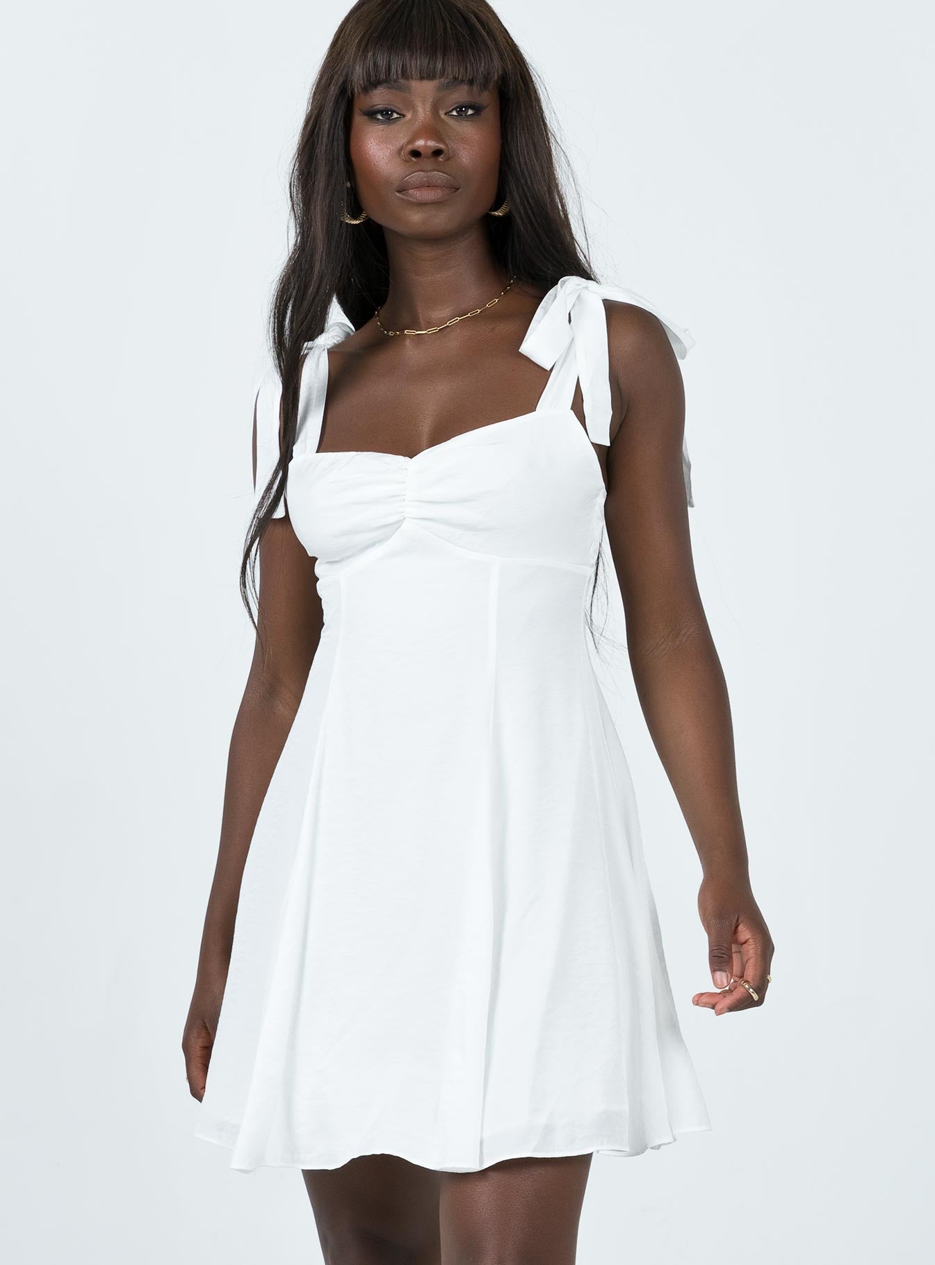 Front view of model wearing  front Princess Polly Asymmetric Neckline  Kinley Mini Dress White