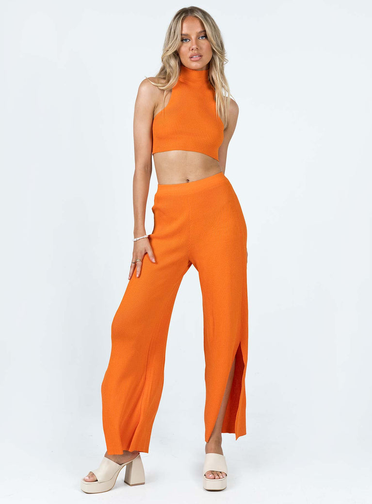 Matching set Ribbed material Tank top Mock neck Low cut sides High waisted pants Elasticated waistband Wide leg Slits at cuff