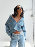 Cropped denim jacket Light wash denim Classic collar Button fastening at front Twin chest pockets Silver-toned hardware Single button cuffs Raw edge hem