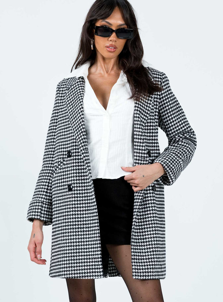 Oversized coat Houndstooth print Soft knit material Double button fastening Twin hip pockets Longline design Fully lined