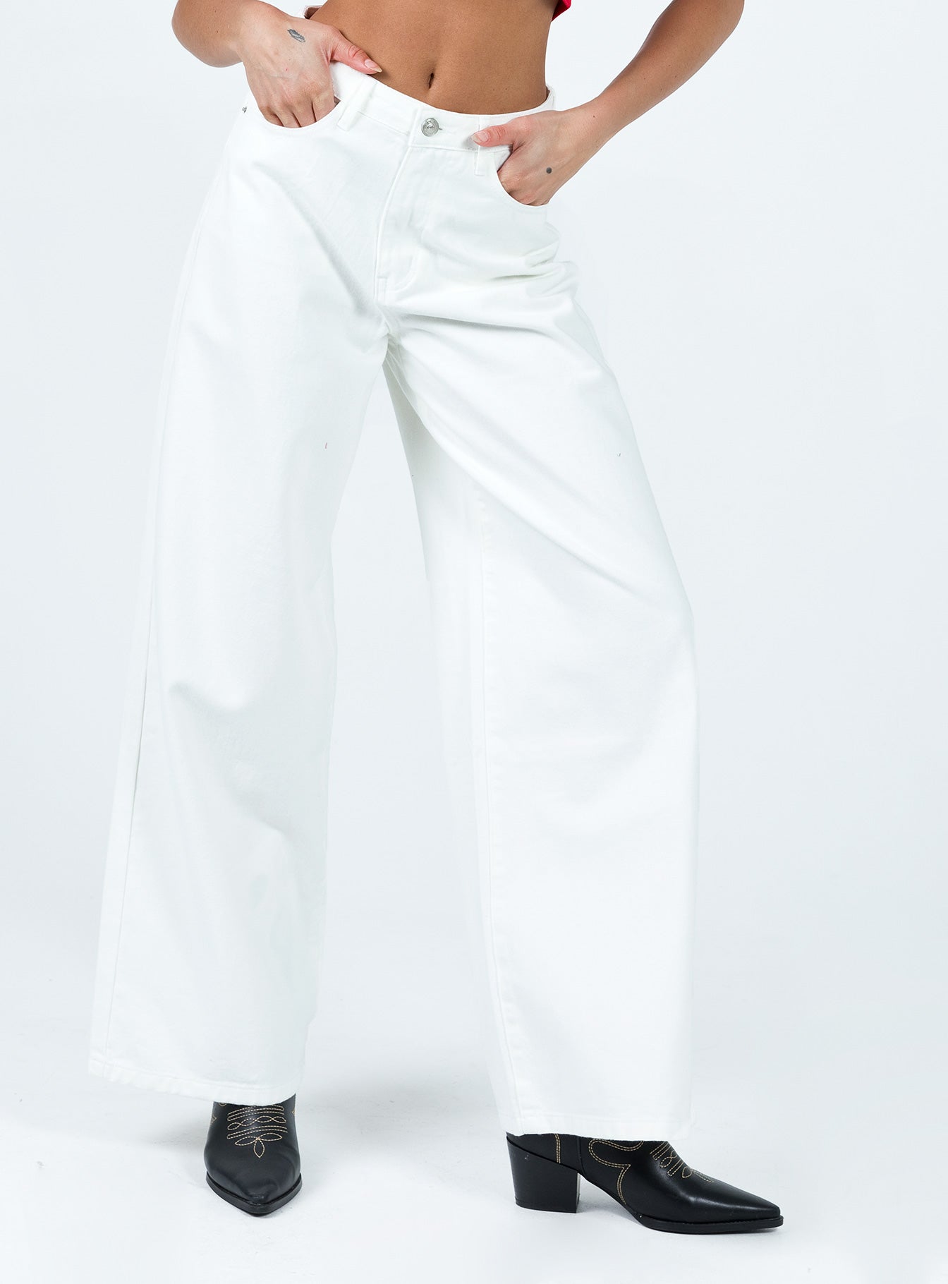 Front view of model wearing  front Princess Polly Mid Rise  Patridge Wide Leg Jeans White