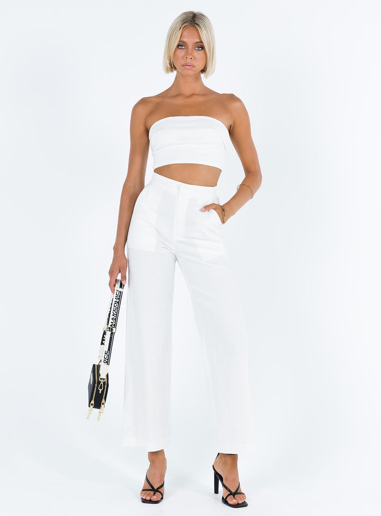 White matching set Linen look material Strapless crop top Folded neckline Inner silicone strip at bust Zip fastening at back High waisted pants Front button and zip fastening  Twin hip pockets