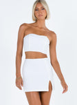 White two piece set Strapless crop top Pearl embellishments at bust Boning through bust Invisible zip fastening at back  Mini skirt Side split Invisible zip fastening at side