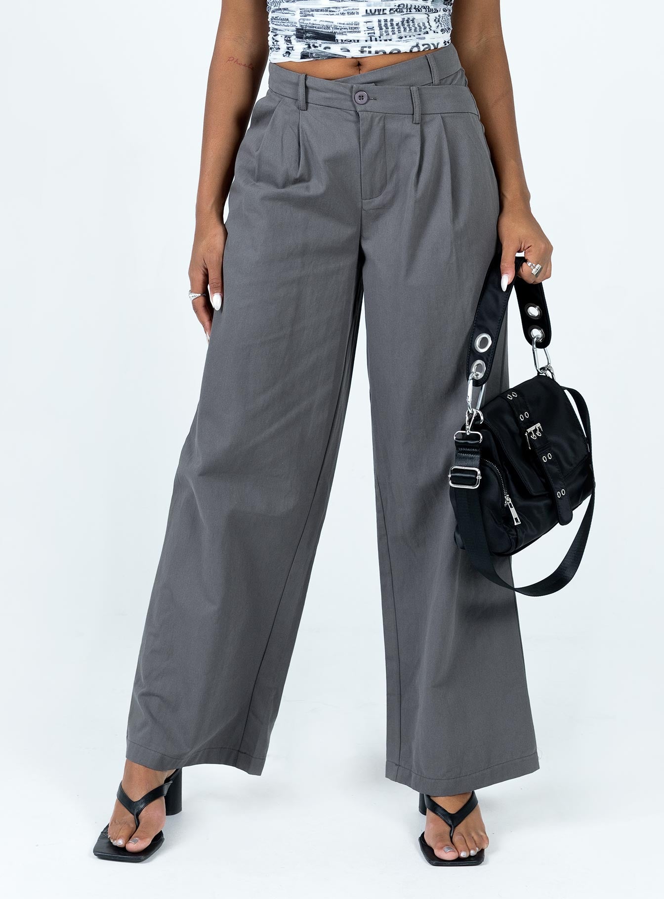 Front view of model wearing  front Princess Polly High Waisted Pants  Mertyl Asymmetric Pants Slate