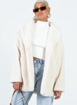 Shearling coat Faux fur material Lapel collar Single button fastening Twin hip pockets