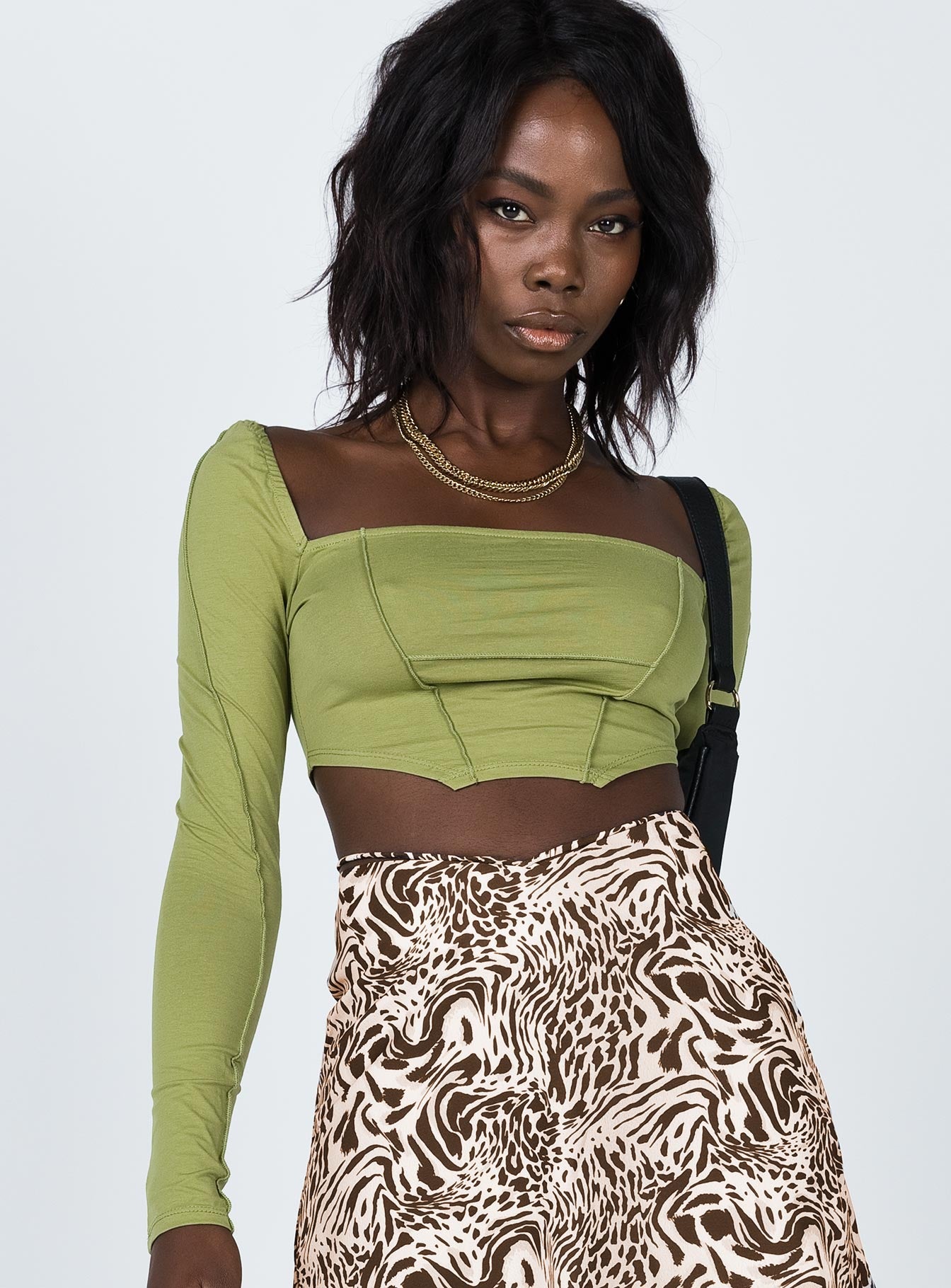 side view of model wearing Princess Polly Blakely Long Sleeve Top Green 