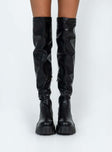 Thigh high boots Faux leather material Platform base Rounded toe Zip fastening at 