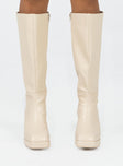 Knee high boot Faux leather material Zip fastening at side Block heel Square toe Padded footbed