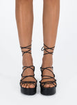 Black heels Faux leather material Strappy upper Shaved block heel Square toe Ankle wrap fastening