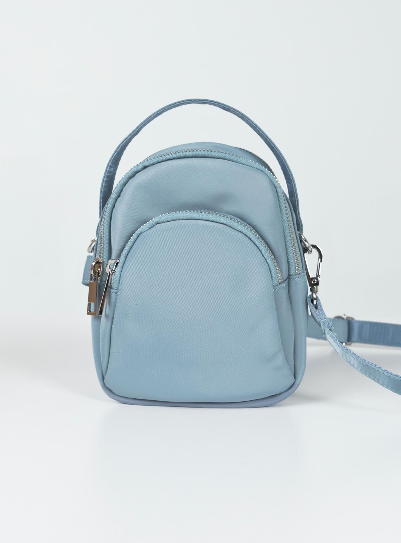 Crossbody bag Nylon material Fixed handle Adjustable & removable crossbody strap Three seperate compartments Zip fastenings Silver-toned hardware