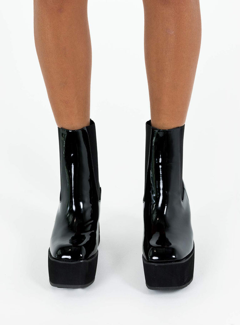 Black platform boots Faux patent leather Ankle boot style Square toe Elastic gusset detailing Pull tab at back