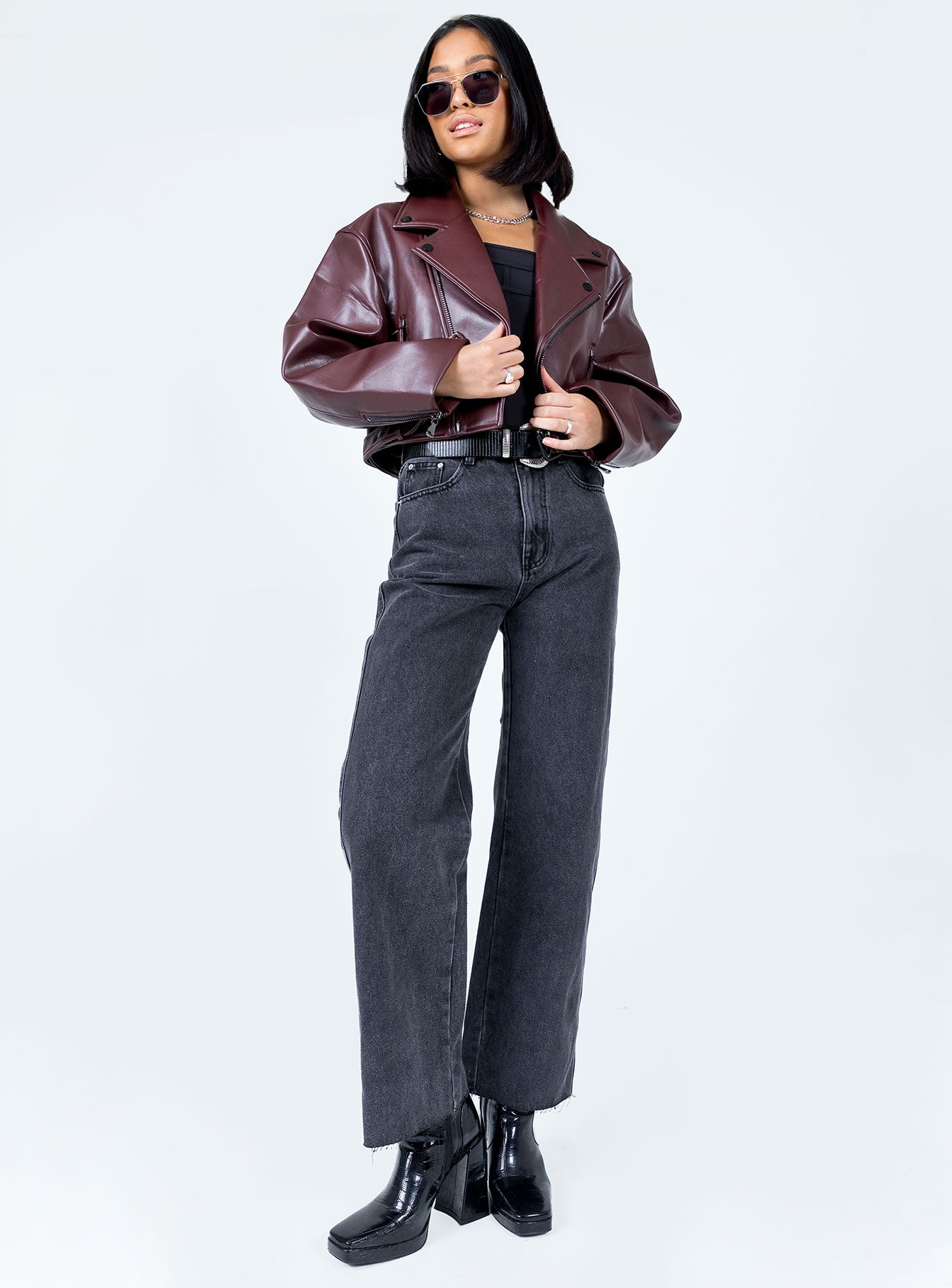 Oversized jacket Faux leather material  Lapel collar  Zip front fastening Twin hip pockets Removable buckle belt Zip at cuffs 