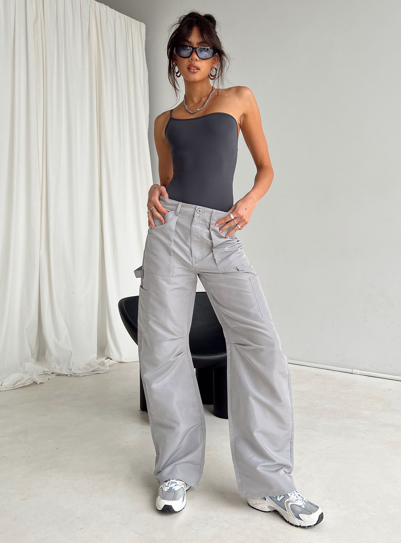 side view of model wearing Princess Polly Hutter Bodysuit Grey Sleeveless Asymmetric Neckline 