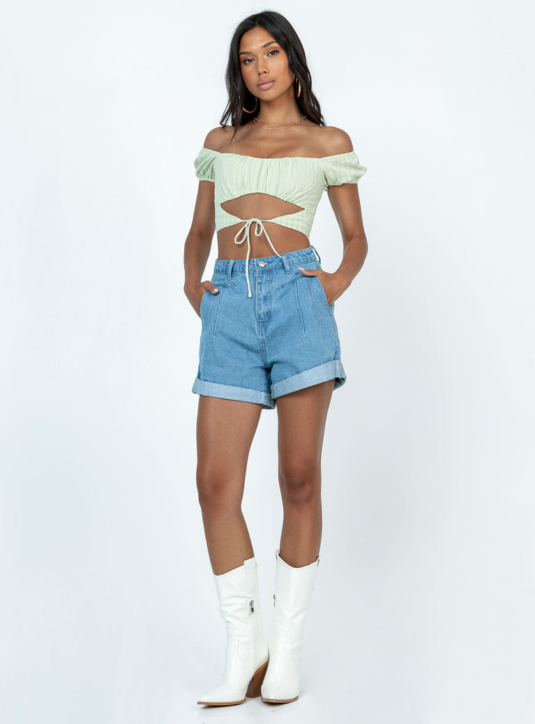 Denim shorts Zip & button fastening  Belt looped waist  Pleated waist  Twin hip pockets  Fixed rolled hem  Branded patch on back 