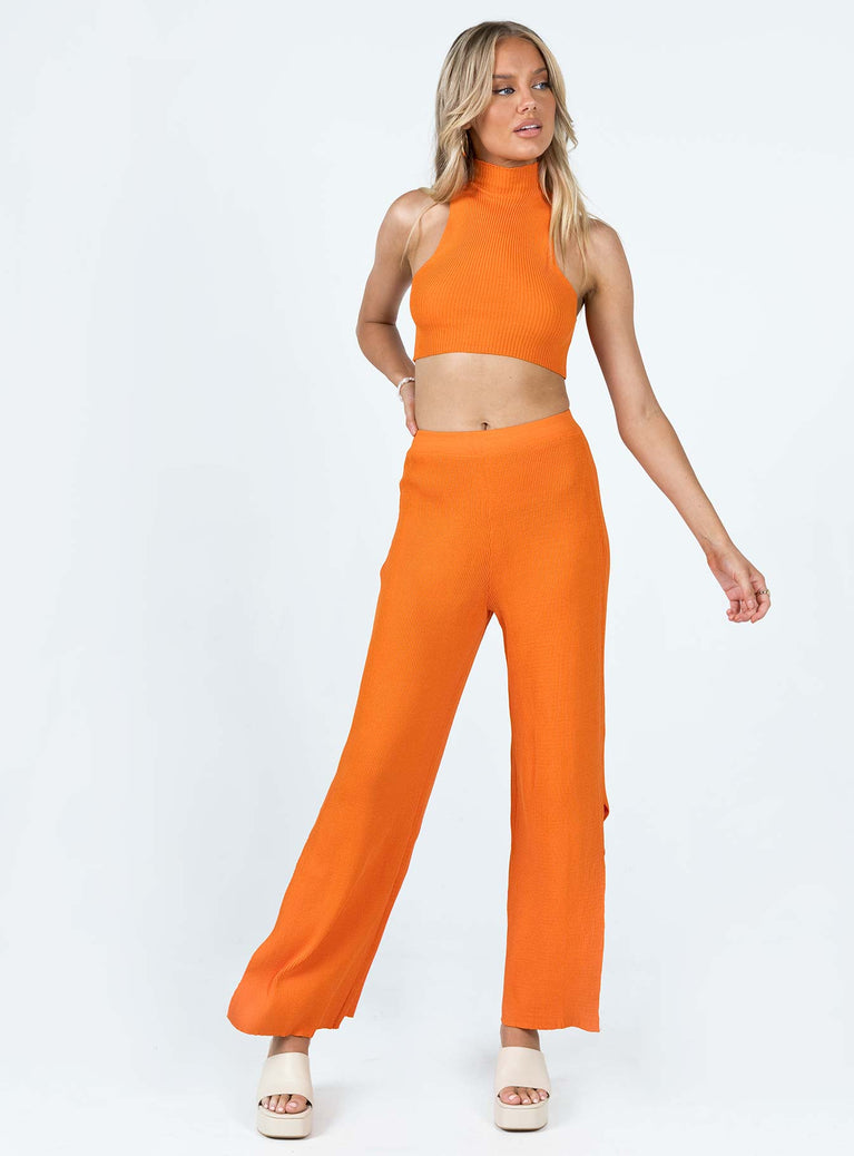 Matching set Ribbed material Tank top Mock neck Low cut sides High waisted pants Elasticated waistband Wide leg Slits at cuff