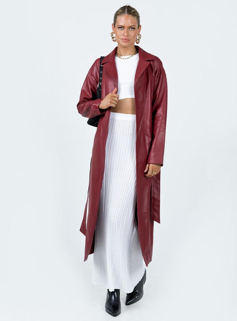 Long coat Faux leather material Lapel collar Removable waist tie Belt loops at waist Twin hip pockets Split hem at back