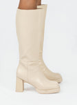 Knee high boot Faux leather material Zip fastening at side Block heel Square toe Padded footbed