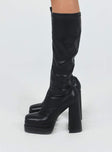 Knee high boots Faux leather material Platform base Rounded toe Zip fastening at side Block heel Padded footbed