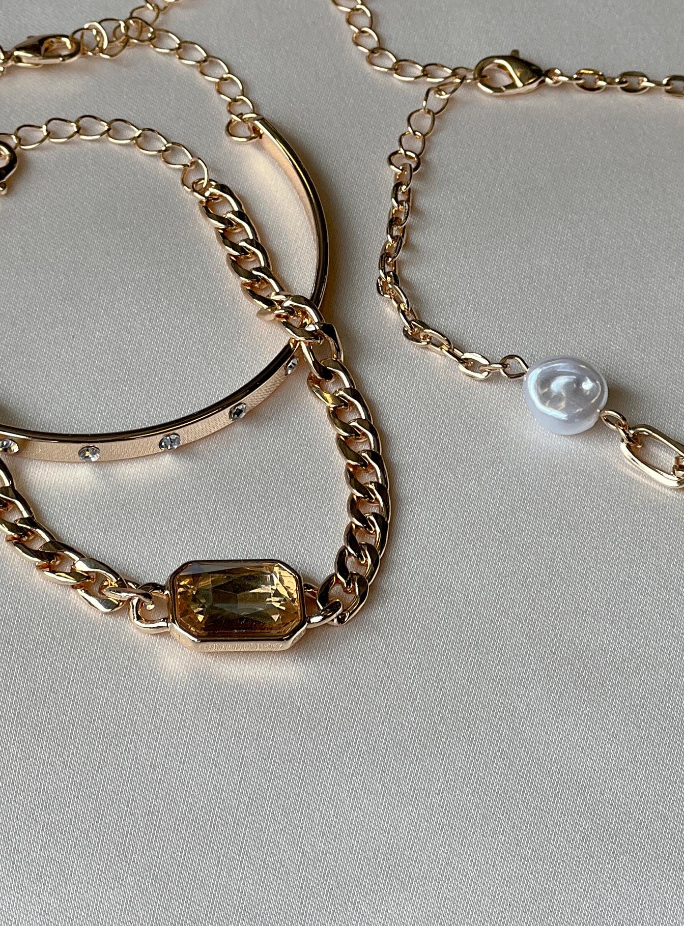 Bracelet Pack of three One bangle style Pearl & diamante detail Lobster clasp fastening Gold-toned