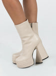 Platform ankle boots  Faux leather material Ankle boot style  Rounded toe Zip fastening at side 