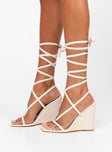 Wedge heels Faux leather material  Strappy upper  Ankle wrap tie fastening Square toe