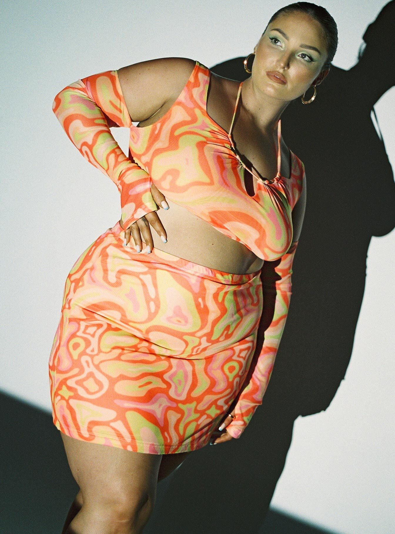   side view of model wearing Princess Polly Balanced Mini Skirt Multi Curve 