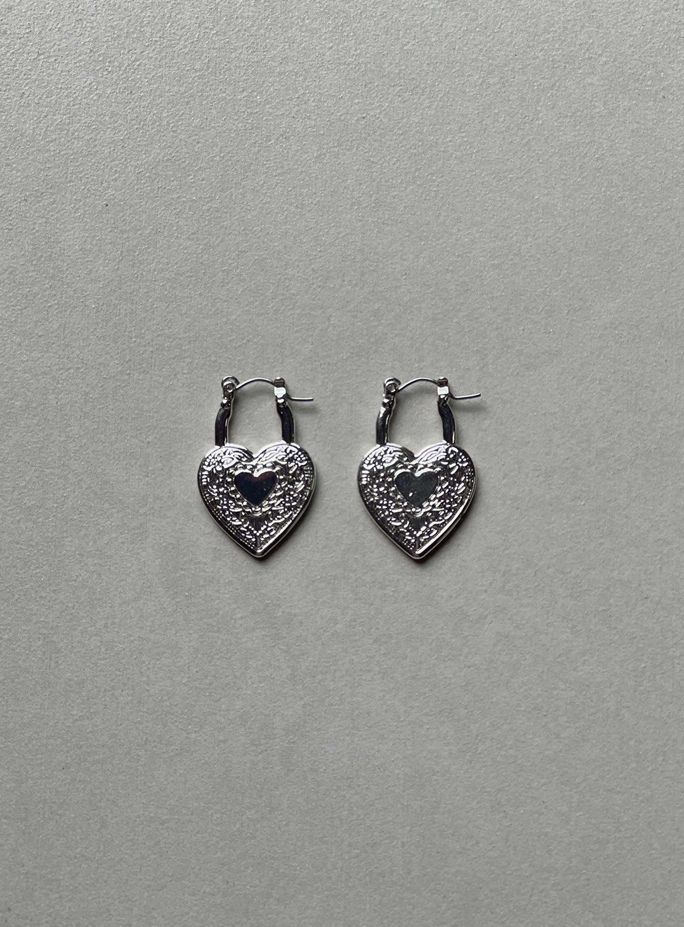 Earrings Hoop style  Silver-toned Latch fastening  Heart design