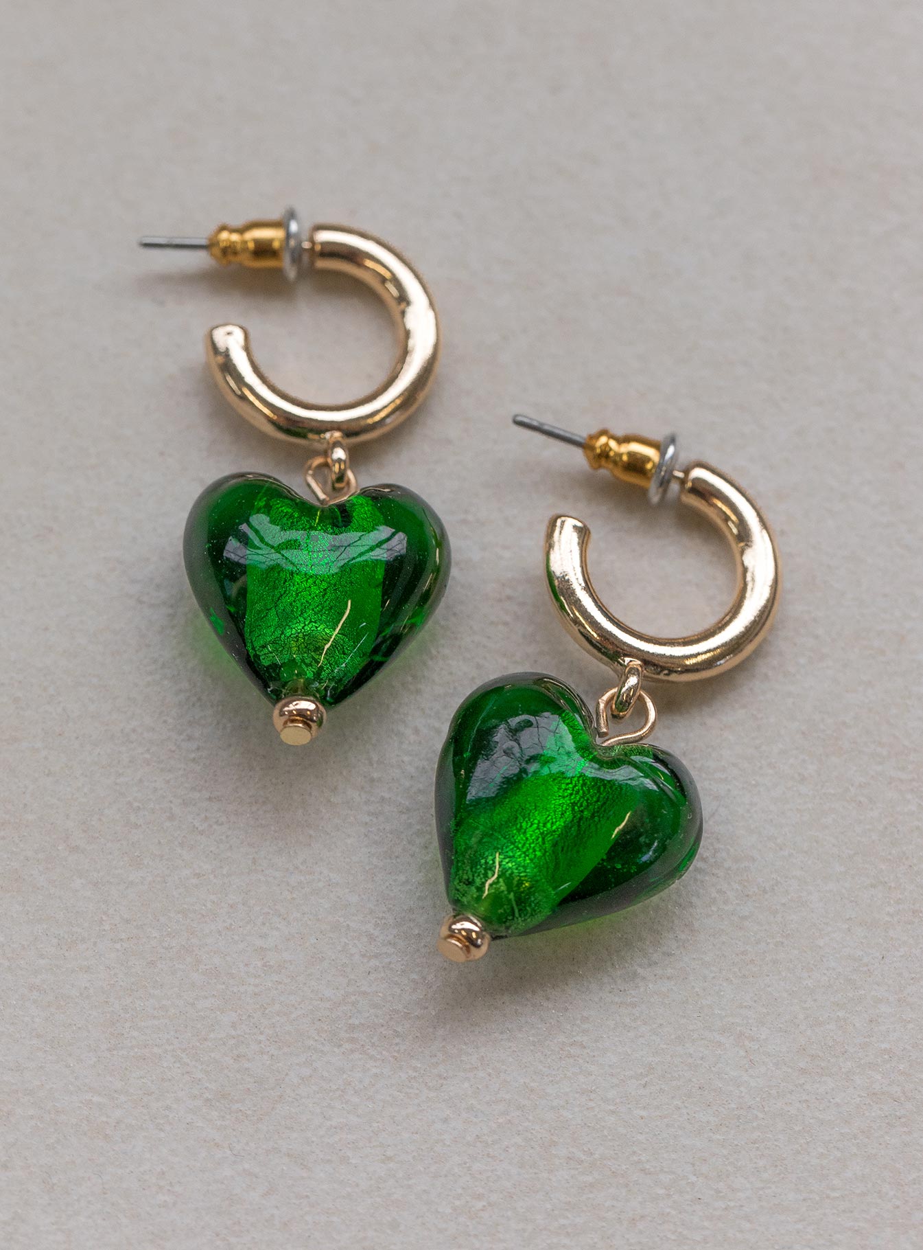 Earrings 55% coloured glaze  40% zinc alloy 5% iron Stud fastening  Hoop look Heart drop charm 