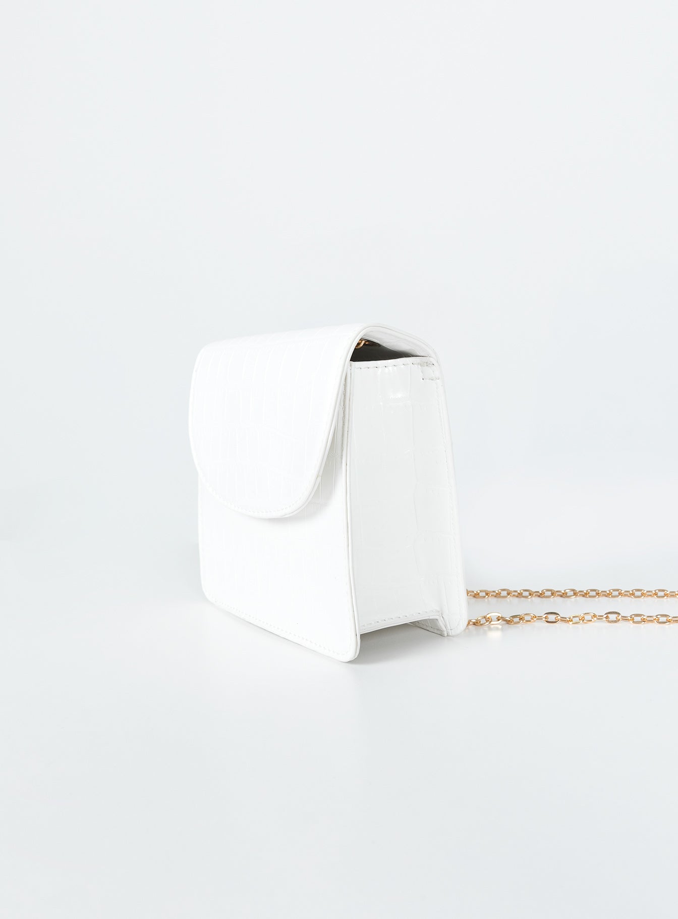 Crossbody bag  Princess Polly Exclusive 100% PU  Faux leather material  Croc print Gold-toned chain strap  Magnetic button fastening  Flat base