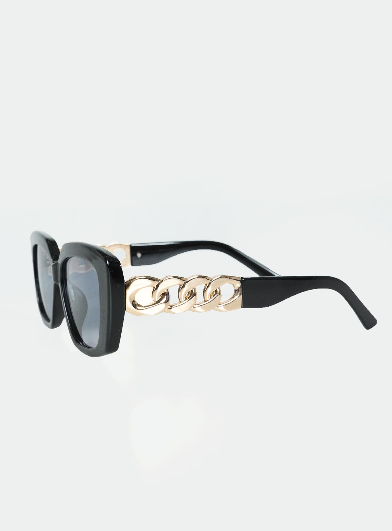 Sunglasses Oversized style Rectangle frame Gold-toned detail on arms Moulded nose bridge Black tinted lenses Lightweight