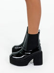 Black platform boots Faux patent leather Ankle boot style Square toe Elastic gusset detailing Pull tab at back