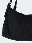 Black bag Canvas material  Silver hardware  Flat base Removable and adjustable straps  Single internal compartment 